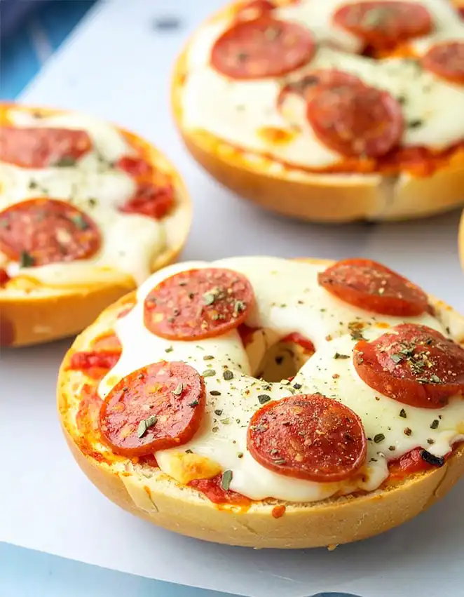 homemade pizza bagels with cheese and pepperoni toppings