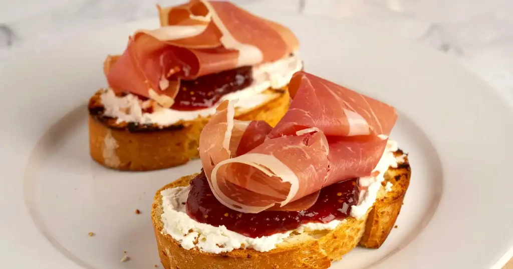 Simple Prosciutto Crostini with cheese and fig jam