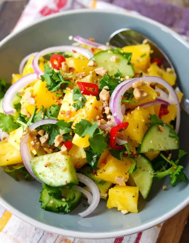 A bowl of cucumber and pineapple salad