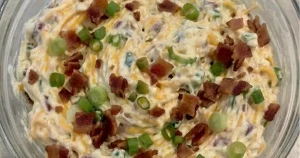 Crreamy Million Dollar Dip with shredded sharp cheddar cheese, bacons, green onions, jalapeno