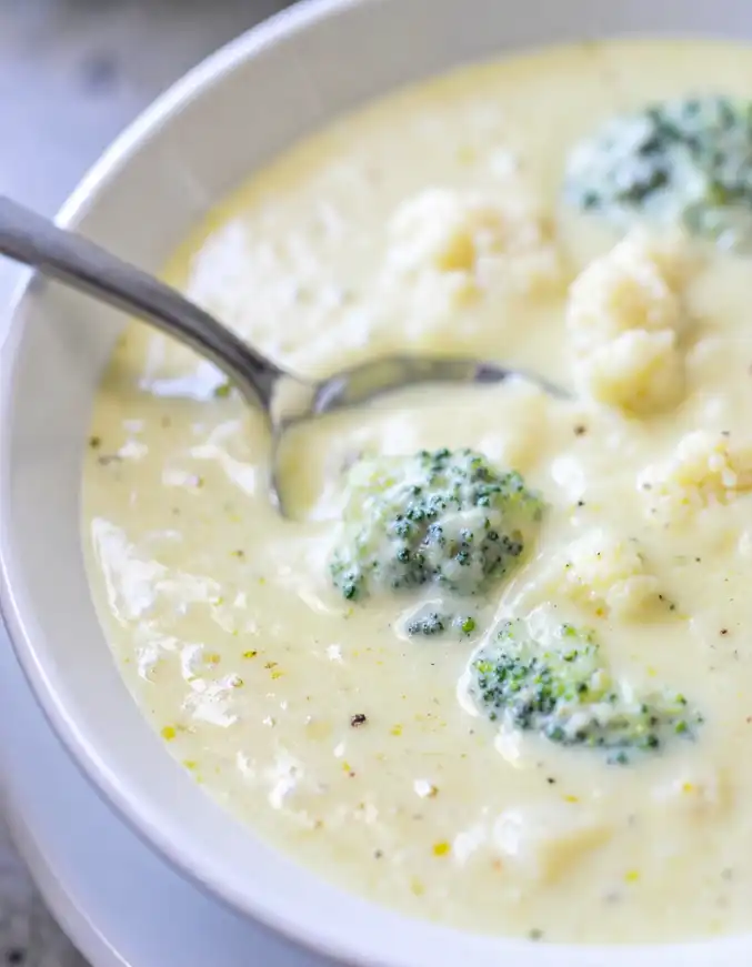 A bowl of Broccoli Cauliflower soup with cheese