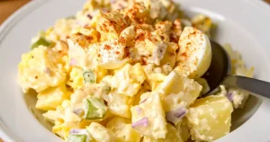 creamy Southern Potato Salad with boiled egg, celery, red onion, spinkled with paprika