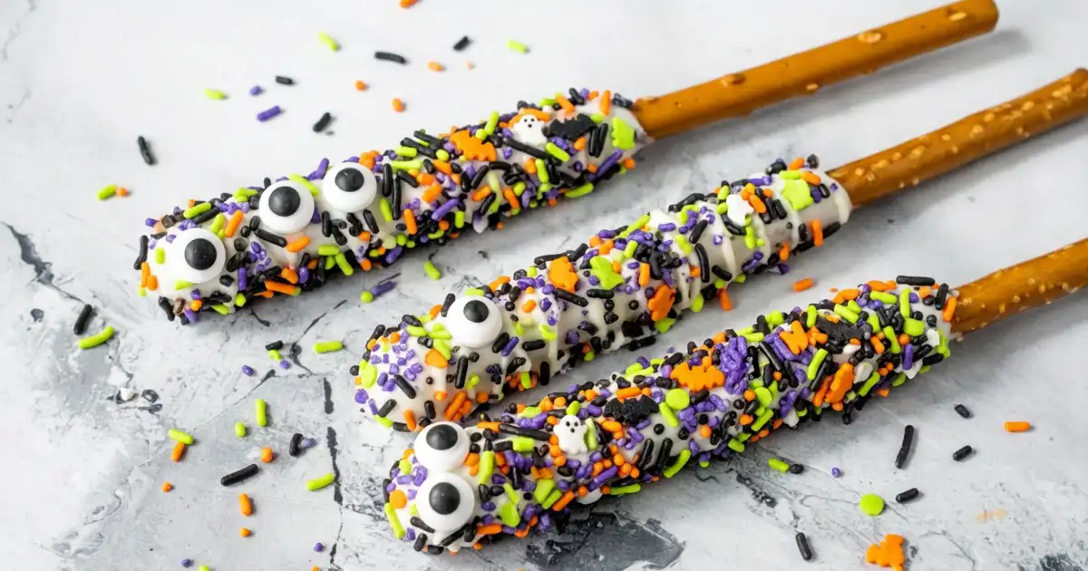 Halloween Pretzels dipped with white candy meltings, coated with Halloween sprinkles