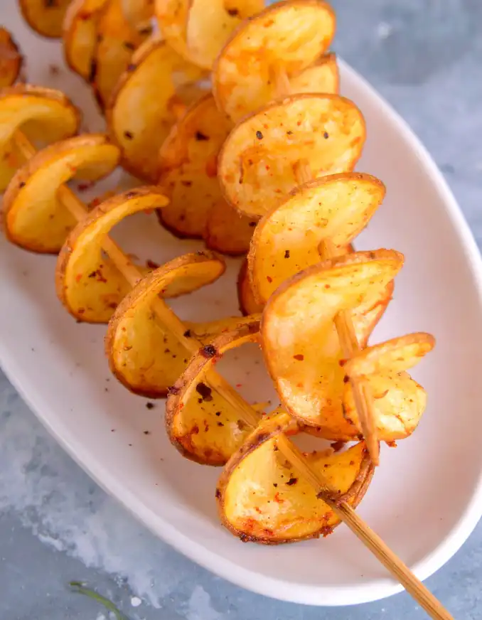 Crispy potato twisters, sprinkled with black pepper and paprika